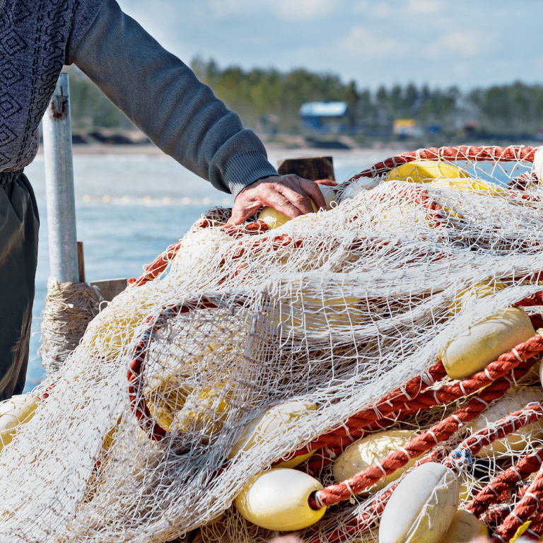 Man with hand on fishing equipment